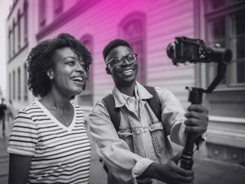 Two people filming themselves with a camera on a gimbal