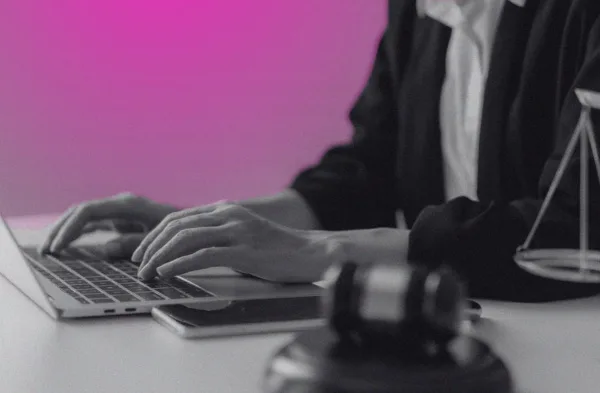 person at laptop with judge's gavel