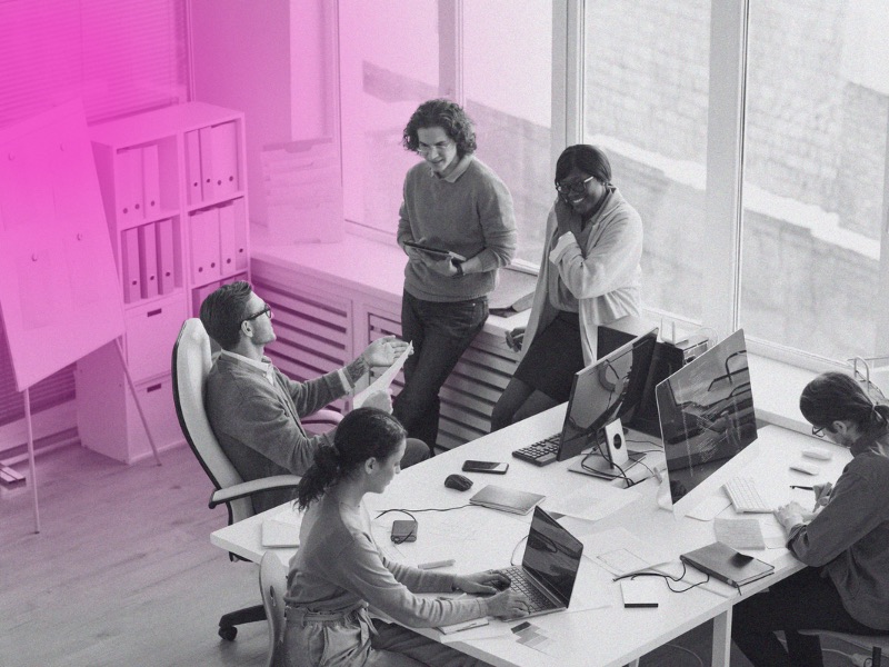 A team having a discussion around a desk