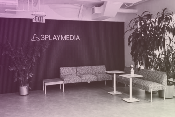 The 3Play Media lobby at 255 State Street in Boston, with the 3Play Media logo on a dark wall, seating, and large potted plants.